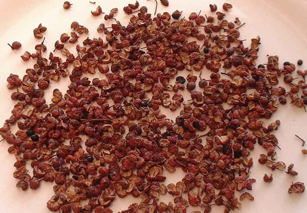 Pink Sichuan peppercorns spread out.
